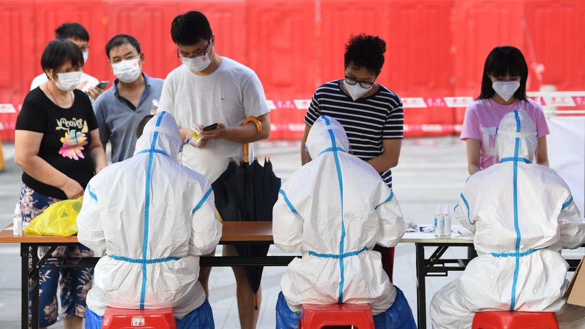 Residents from Guangzhou’s Liwan district register for Covid-19 tests as the city tries to contain an outbreak.